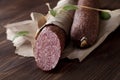 Salami on wooden and paper Royalty Free Stock Photo