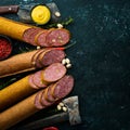 Salami with pistachios, hazelnuts and rosemary and spices on a black background. Royalty Free Stock Photo