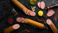 Salami with pistachios, hazelnuts and rosemary and spices on a black background. Royalty Free Stock Photo