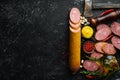 Salami with pistachios, hazelnuts and rosemary and spices on a black background. Royalty Free Stock Photo