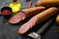 Salami with pistachios, hazelnuts and rosemary and spices on a black background. Royalty Free Stock Photo