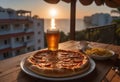 Salami Pizza and Beer with Ocean Sunset View