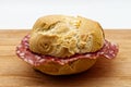 Salami sandwich. Panino al salame on wooden table Royalty Free Stock Photo