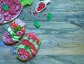 Salami sandwich with tomatoes and cucumbers next sliced salami and tomato and Basil leaves with salad on wooden background Royalty Free Stock Photo