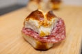 A salami sandwich on a wooden cutting board. Royalty Free Stock Photo