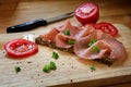Salami sausage slices on a dark wholegrain bread, tomato and par Royalty Free Stock Photo