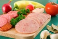 Salami and sausage slices and vegetables Royalty Free Stock Photo