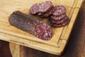 Salami sliced on wooden board Royalty Free Stock Photo