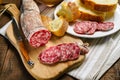 Salami sliced on wooden cutting board. Royalty Free Stock Photo