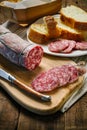 Salami sliced on wooden cutting board. Royalty Free Stock Photo