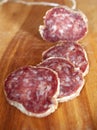 Salami slices on wood trencher