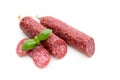 Salami smoked sausage, basil leaves and peppercorns isolated on white background Royalty Free Stock Photo