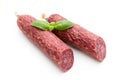 Salami smoked sausage, basil leaves and peppercorns isolated on white background Royalty Free Stock Photo