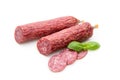 Salami smoked sausage, basil leaves and peppercorns isolated on white background Royalty Free Stock Photo