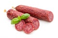 Salami smoked sausage, basil leaves and peppercorns isolated on white background Royalty Free Stock Photo