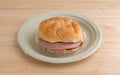 Salami sub sandwich on plate atop a table Royalty Free Stock Photo