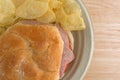 Salami sub sandwich on plate with chips on table Royalty Free Stock Photo