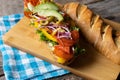 Salami sub sandwich in rustic baguette with olives and sprouts Royalty Free Stock Photo