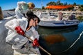 Workers try to clean up oil that has washed ashore, on a beach o