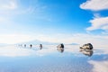 Off-road cars driving through the salt flat Salar de Uyuni