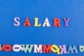 SALARY word on blue background composed from colorful abc alphabet block wooden letters, copy space for ad text. Learning english Royalty Free Stock Photo