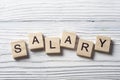 SALARY word written on wood block at wooden background. Royalty Free Stock Photo