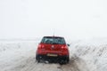 Salavat, Russia - February 26, 2017: dangerous driving, road with car in blizzard