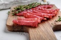 Salchichon whole and sliced cuts, spanish sausage on white surface Royalty Free Stock Photo