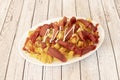 Salchipapa or salchipapas is a fast food consisting of fried slices of sausage and French fries, consumed