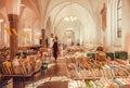 Sale of antique books and some customers inside historical church