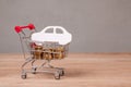 Sale or buy car. Shopping cart full of coins and car symbol Royalty Free Stock Photo