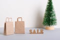 Sale before christmas inscription and paper craft bags on the table