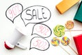 Sale concept with megaphone. Declare the sale. Electronic megaphone near word sale in cloud, gift boxes and sweets on