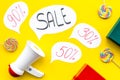 Sale concept with megaphone. Declare the sale. Electronic megaphone near word sale in cloud, gift boxes and sweets on Royalty Free Stock Photo