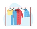 Sale concept, womens clothes hanging on rack. Coat, cotton t-shirt and pants, modern jacket in wardrobe. Female fashion