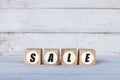 sale concept written on wooden cubes or blocks, on white wooden background. Royalty Free Stock Photo