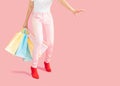 Sale and consumerism concept-Part body,Low Section Of Woman Holding Shopping Bag Against Pink Background Royalty Free Stock Photo