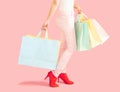 Sale and consumerism concept-Part body,Low Section Of Woman Holding Shopping Bag Against Pink Background Royalty Free Stock Photo