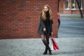 Sale, consumerism and people concept - happy young beautiful women holding shopping bags, walking away from shop. Royalty Free Stock Photo