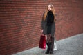 Sale, consumerism and people concept - happy young beautiful women holding shopping bags, walking away from shop. Royalty Free Stock Photo