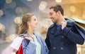 Happy young couple with shopping bags in mall Royalty Free Stock Photo