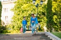 Sale, consumerism and people concept - happy young women her dauther with shopping bags walking city street Royalty Free Stock Photo