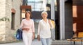 Senior women with shopping bags walking in city Royalty Free Stock Photo