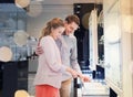 Happy couple choosing engagement ring in mall Royalty Free Stock Photo