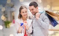 Couple with smartphone and shopping bags in mall Royalty Free Stock Photo