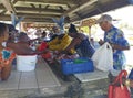 Sale of fresh fish in an Antillean market stall. A group of Caribbean people buy freshly caught fish.