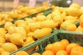 Sale of lemons in the supermarket. Citrus fruits in plastic boxes