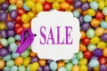 Sale message gift tag over colorful jellybean candy