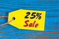 Sale minus 25 percent. Big sales twenty five percents on blue wooden background for flyer, poster, shopping, sign