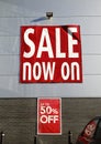 Sale now on - large red poster advertising a sale with 50% reductions.